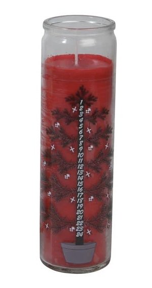 Red calendar candle in glass with Christmas tree